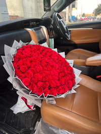 Century of Purity 100 red roses bouquet delivered by Petals in Lahore